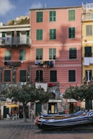 a boat is parked in front of a row of buildings