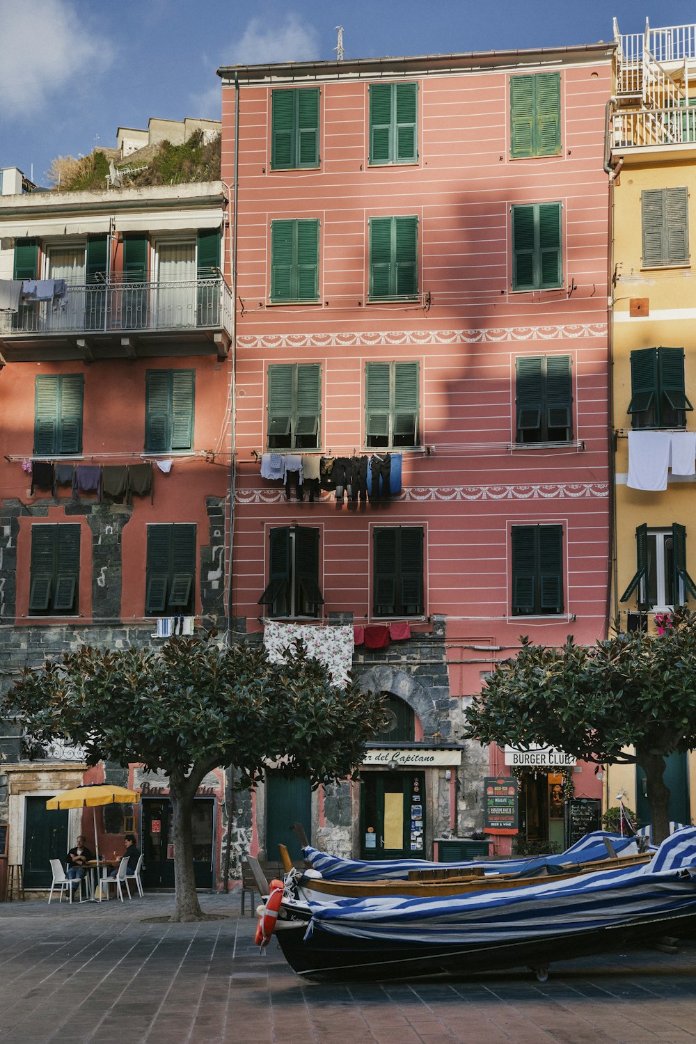 a boat is parked in front of a row of buildings