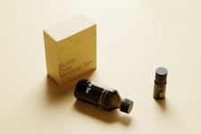 a bottle of perfume sitting next to a box