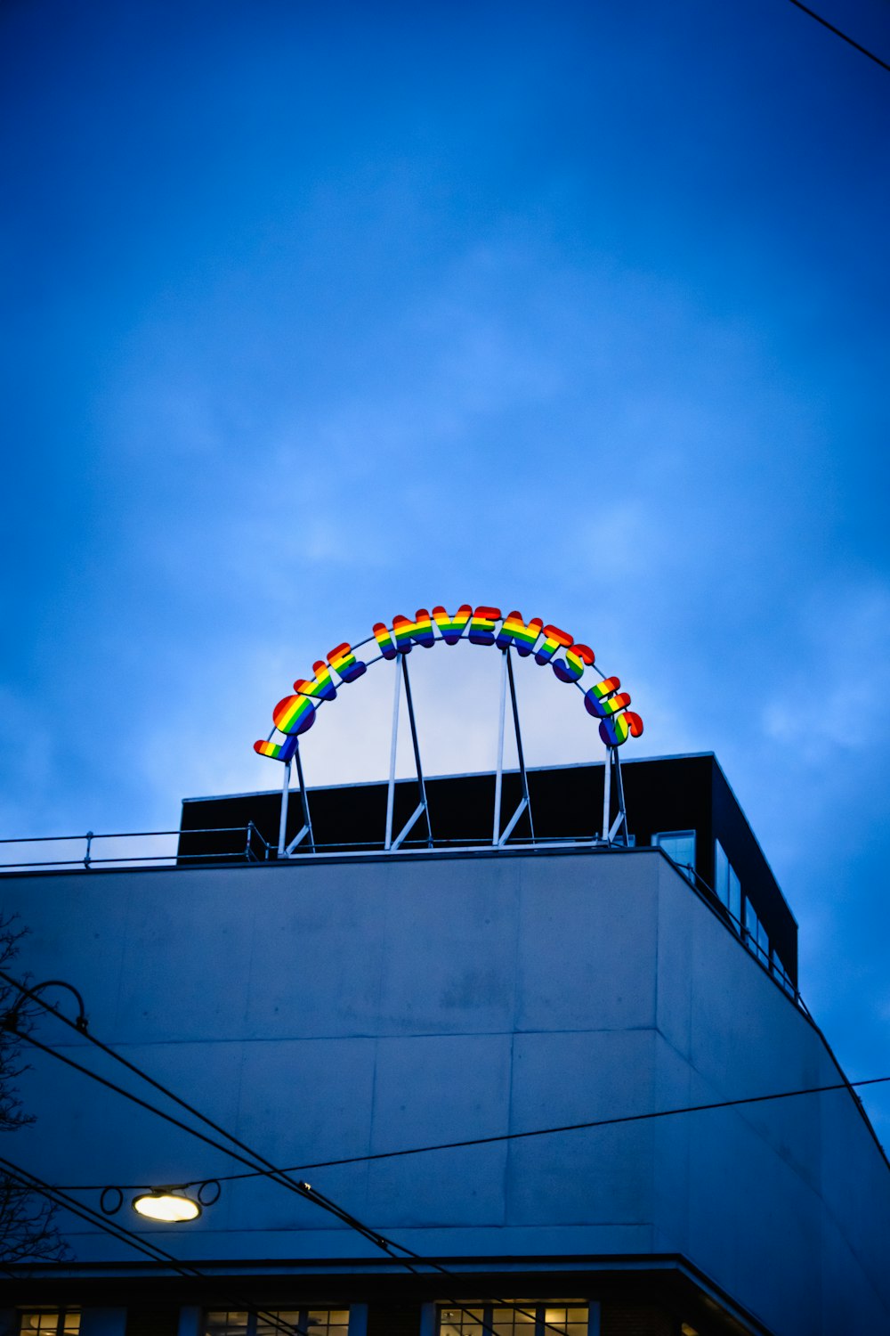 a building with a rainbow sign on top of it