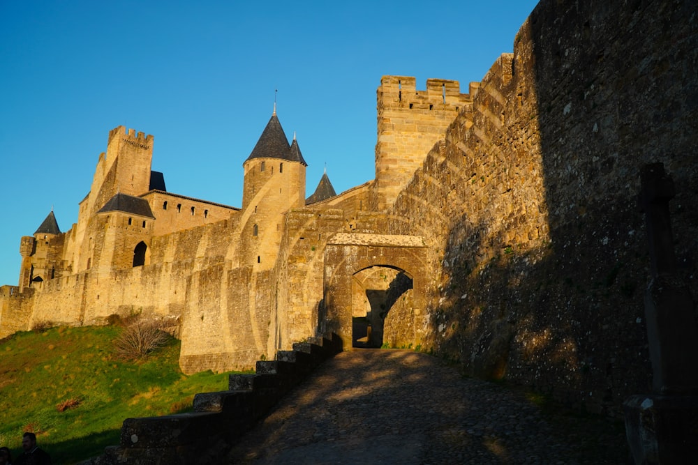 an old castle with a stone walkway leading to it