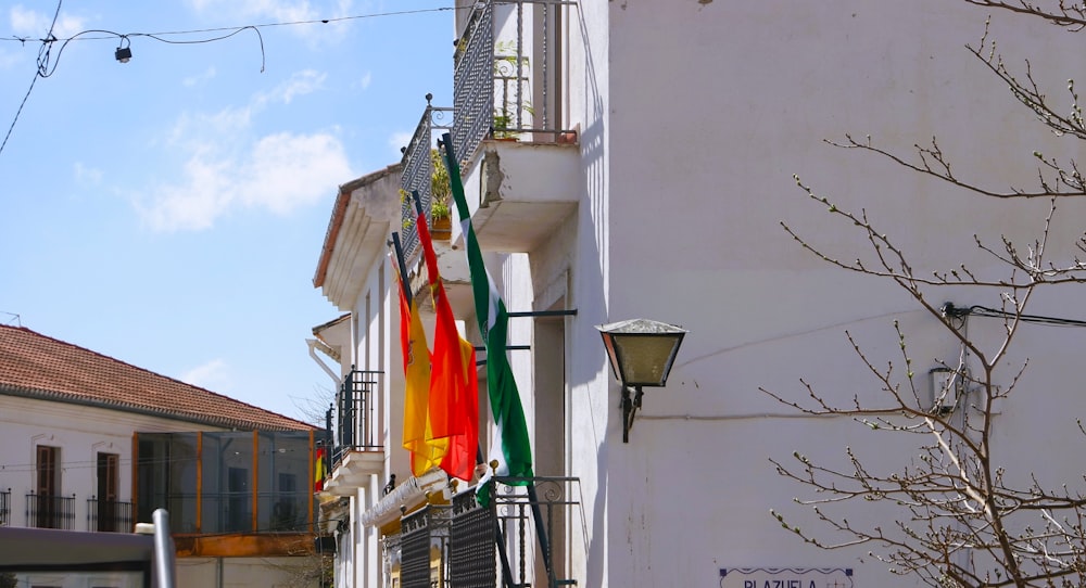 a building with a bunch of flags hanging from it's side