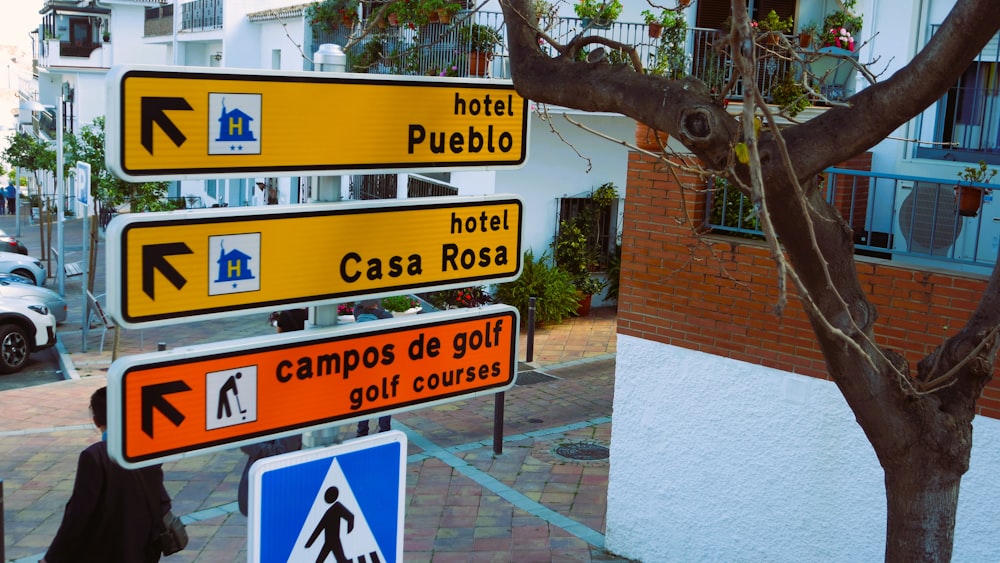 a bunch of street signs on a city street