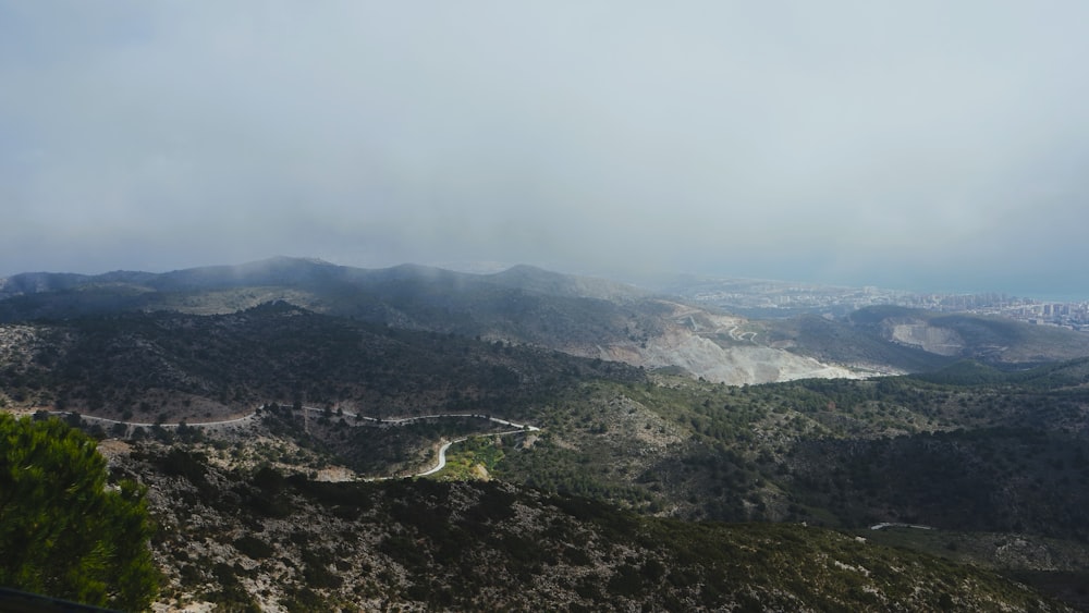 a view of a mountain range with a road winding through it