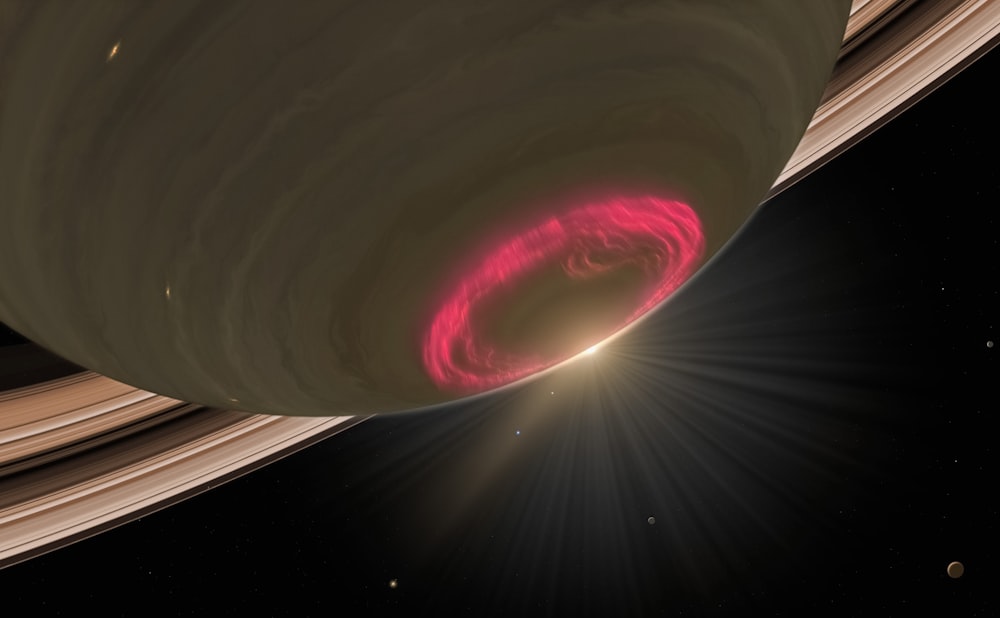 土星の周りを回る赤い環のアーティストの印象
