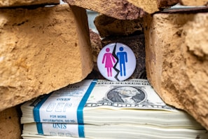 a pile of money with a button on top of it