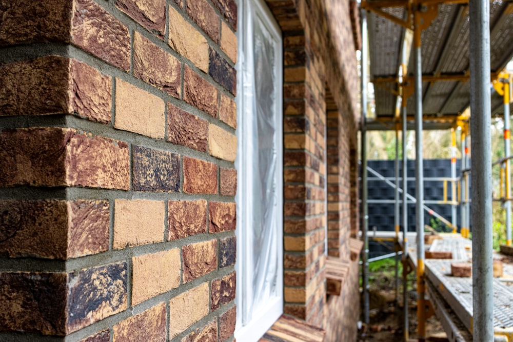 a brick building with scaffolding on the side of it