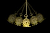 a group of clocks hanging from a chain
