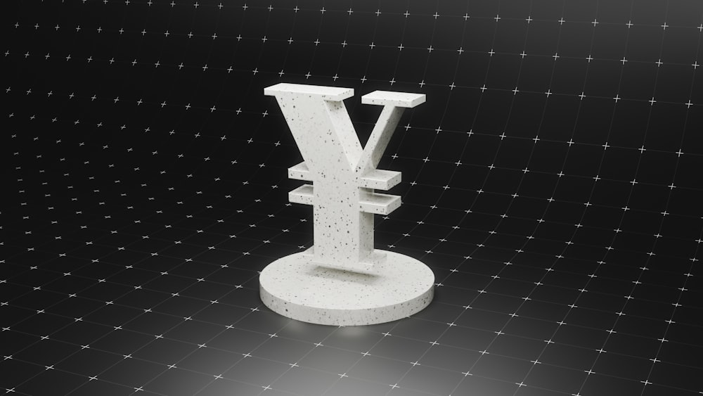 a sculpture of a letter v on a black background