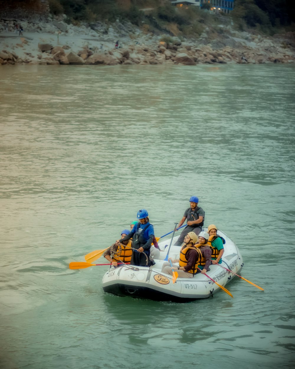 a group of people riding on the back of a raft