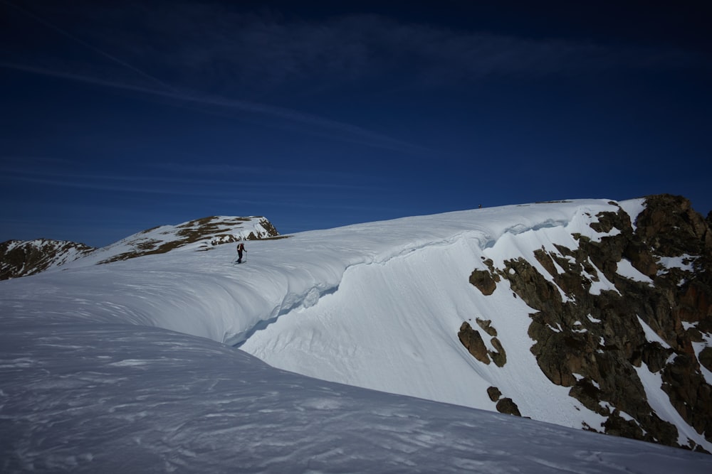 a man standing on top of a snow covered mountain