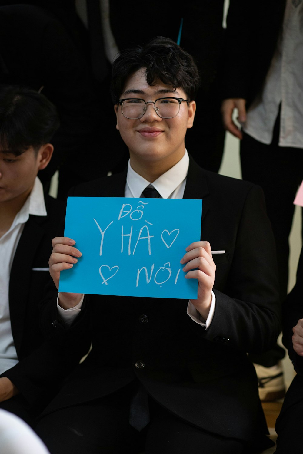 a man in a suit holding a sign that says yes ya ya not