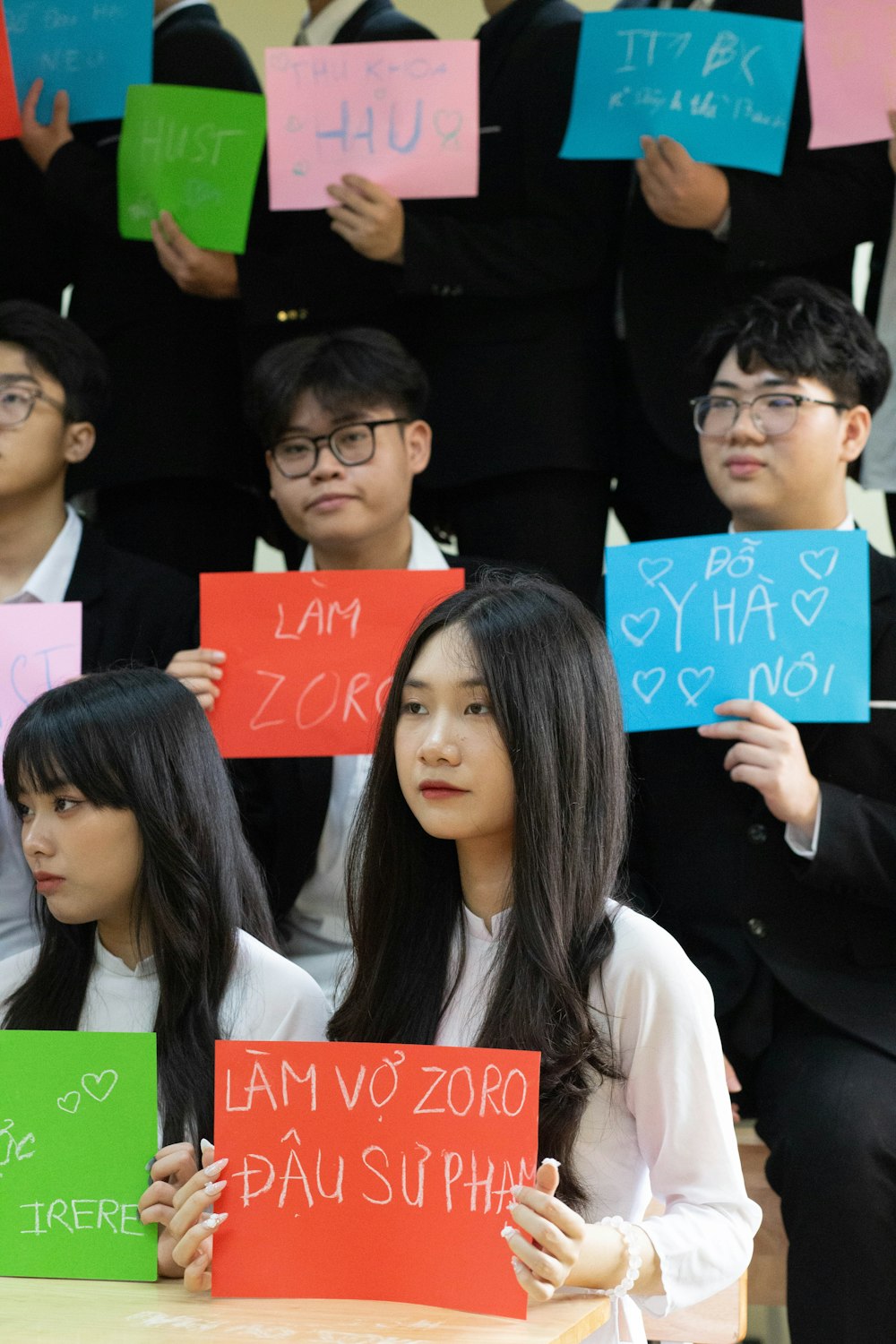a group of young people holding up signs