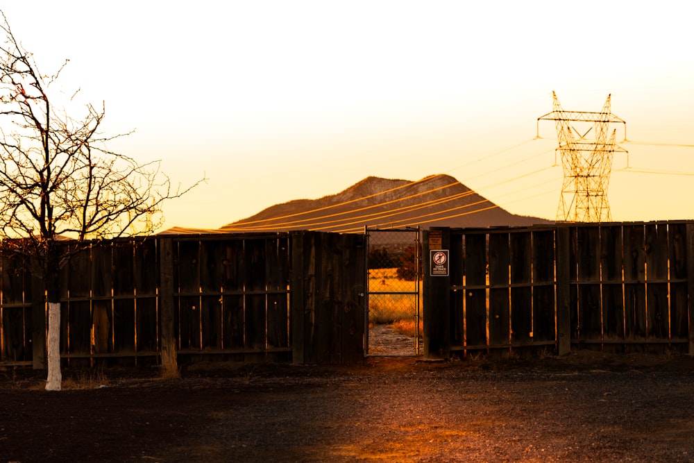 a wooden fence with a tent in the background