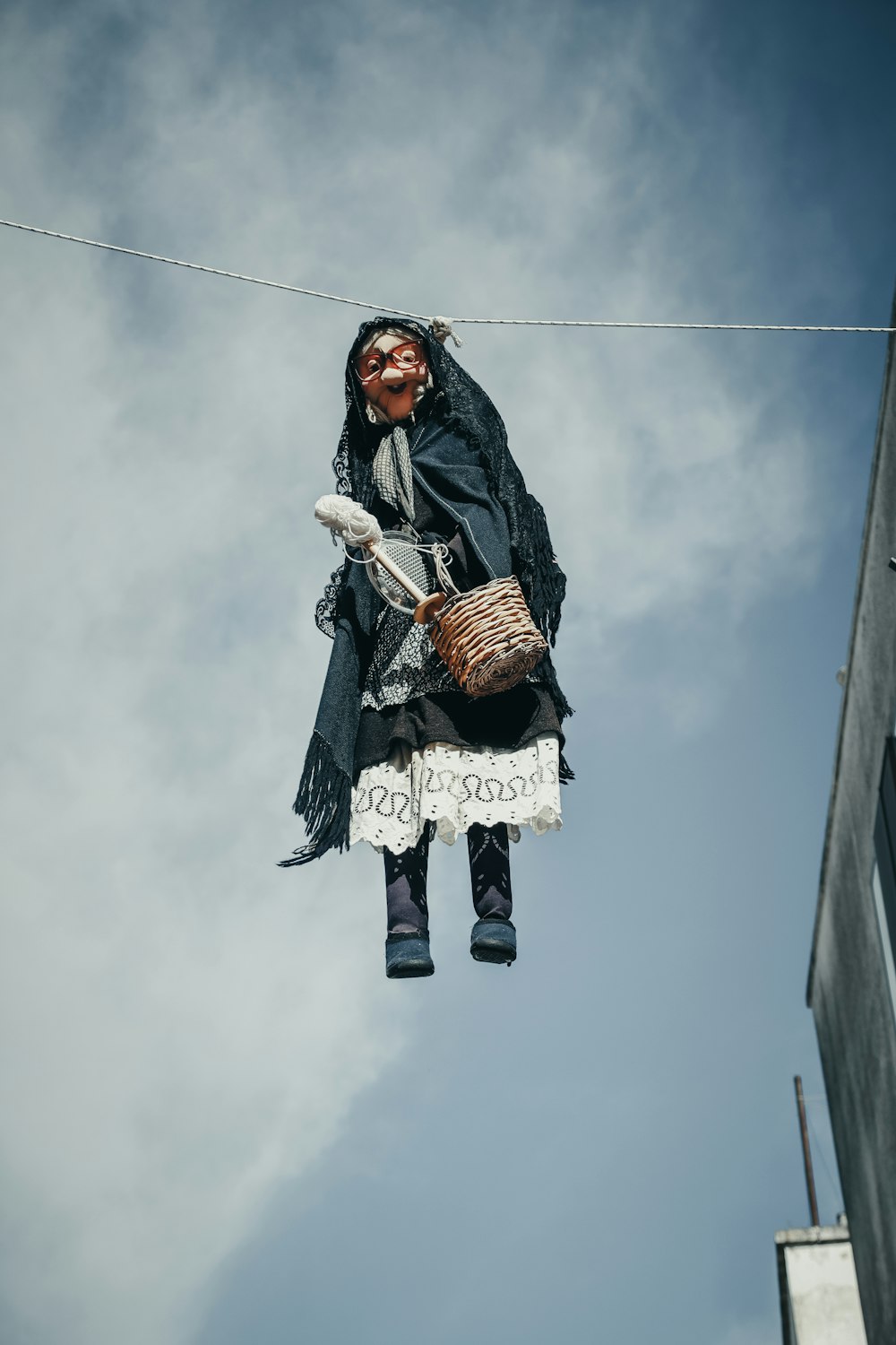 a woman hanging from a wire with a basket