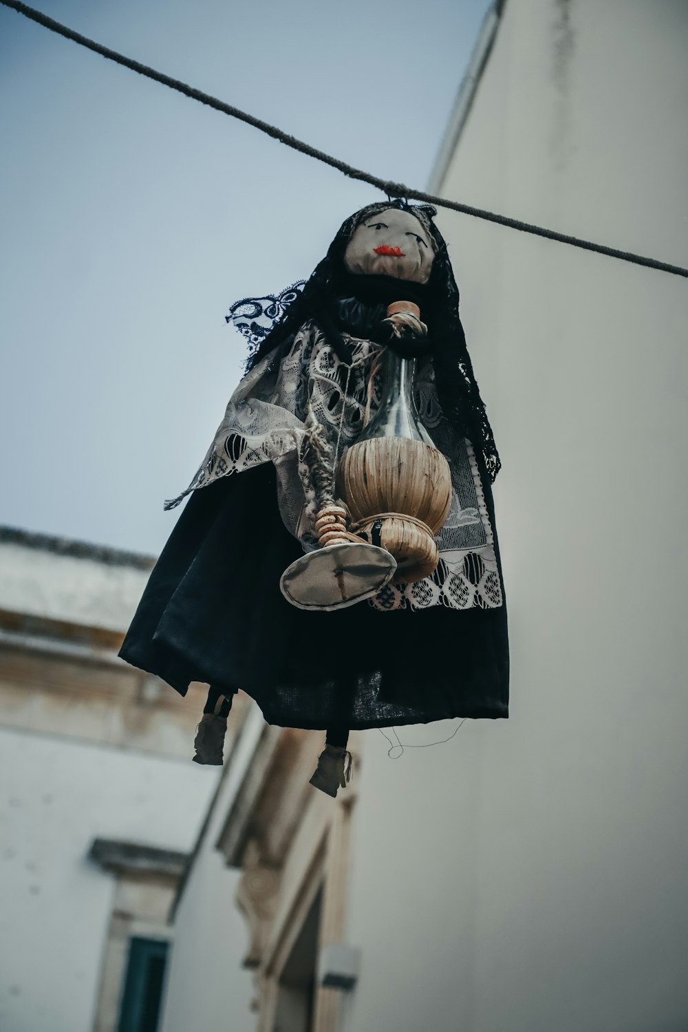 a creepy doll hanging from a clothes line