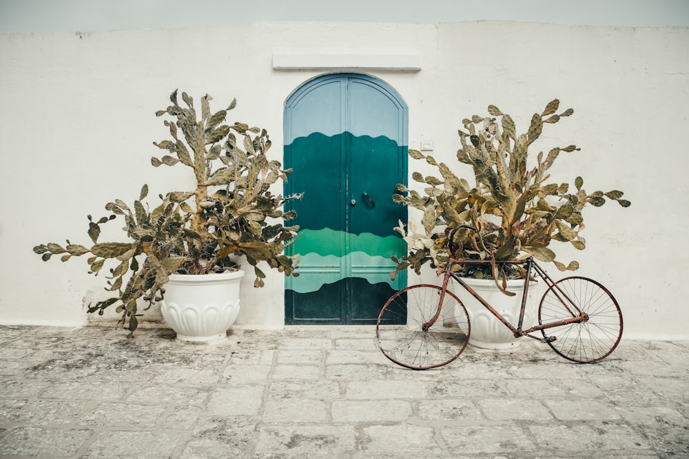 a bike parked next to a green door