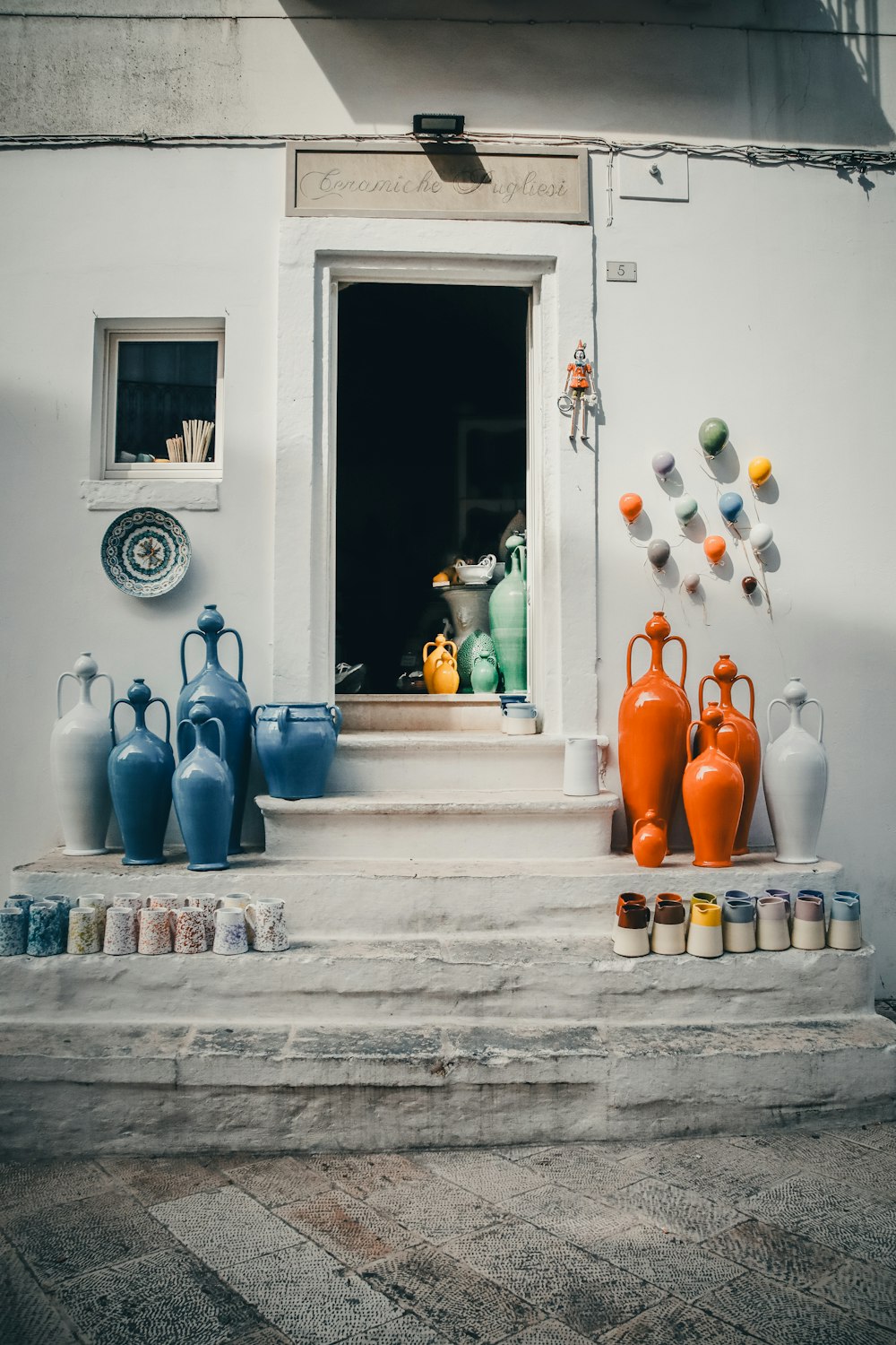 a group of vases sitting on the steps of a building