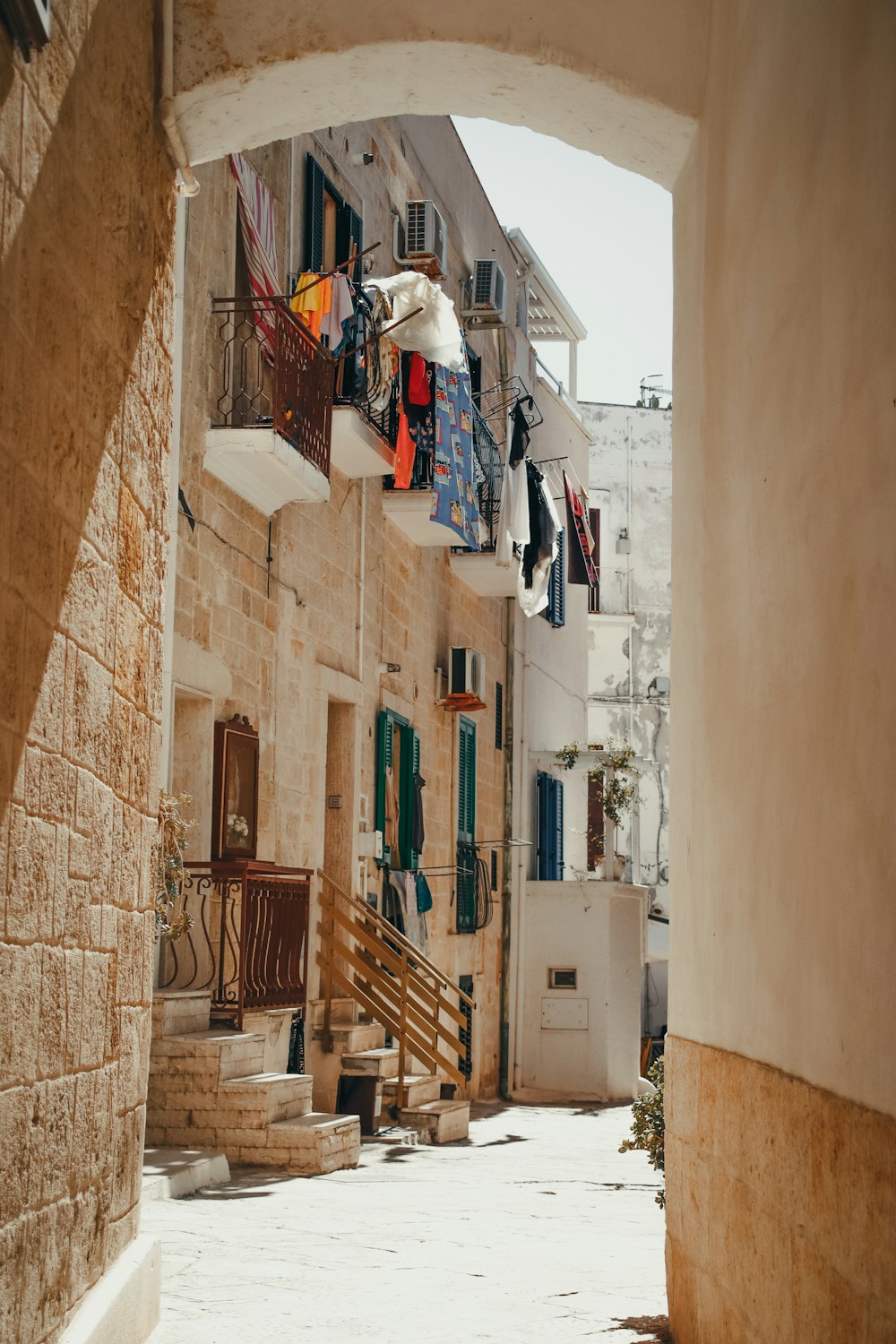 a narrow alley way with clothes hanging out to dry