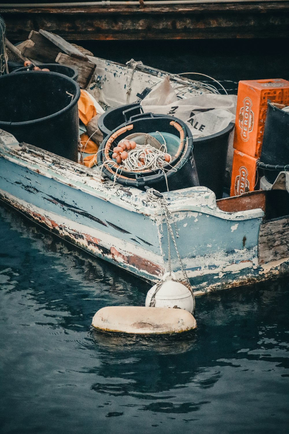 a boat with a bunch of items on it floating in the water