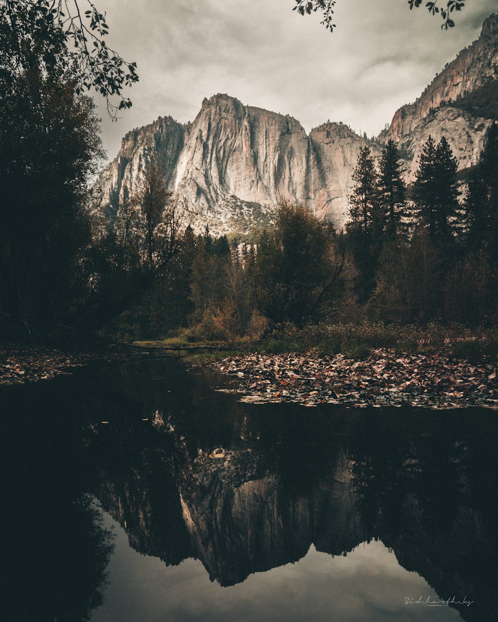 a mountain is reflected in the still water of a lake