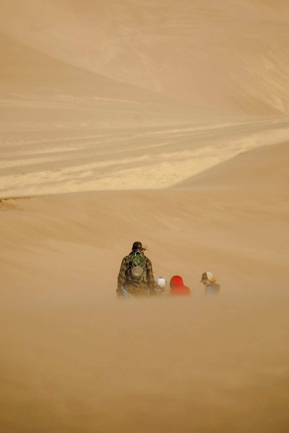 a man sitting on top of a sandy beach