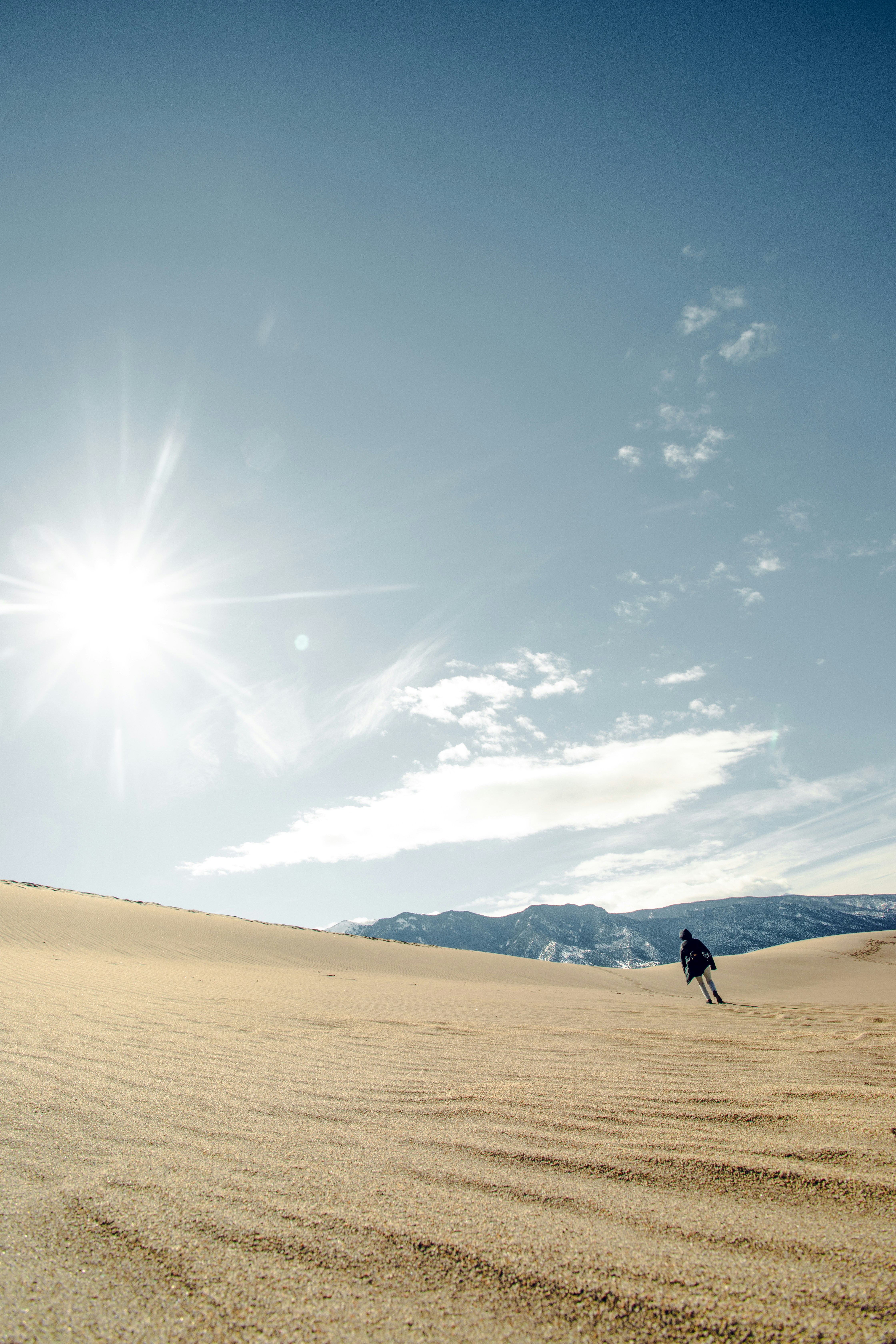 a person riding skis across a sandy field