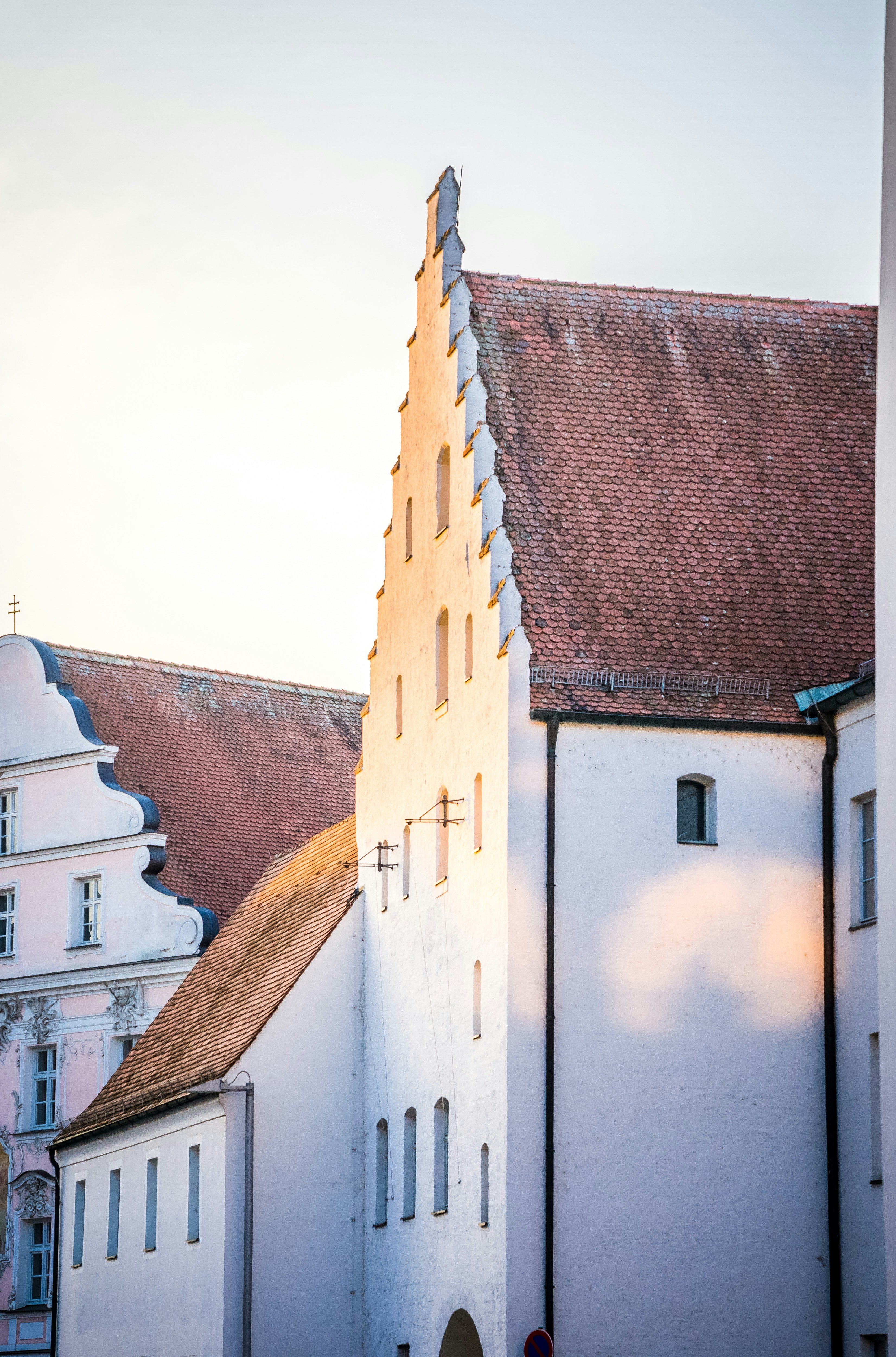 a tall white building with a clock on it's side