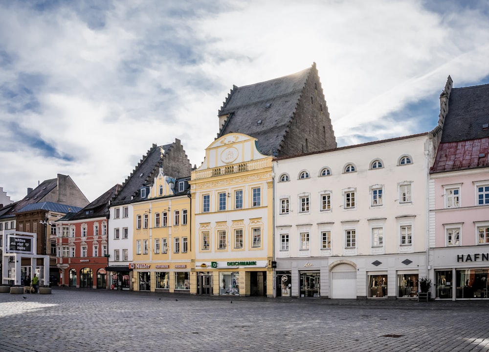 a row of buildings with a clock tower in the middle