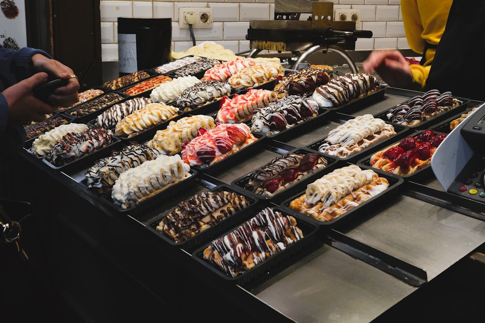 a buffet table filled with lots of different types of donuts