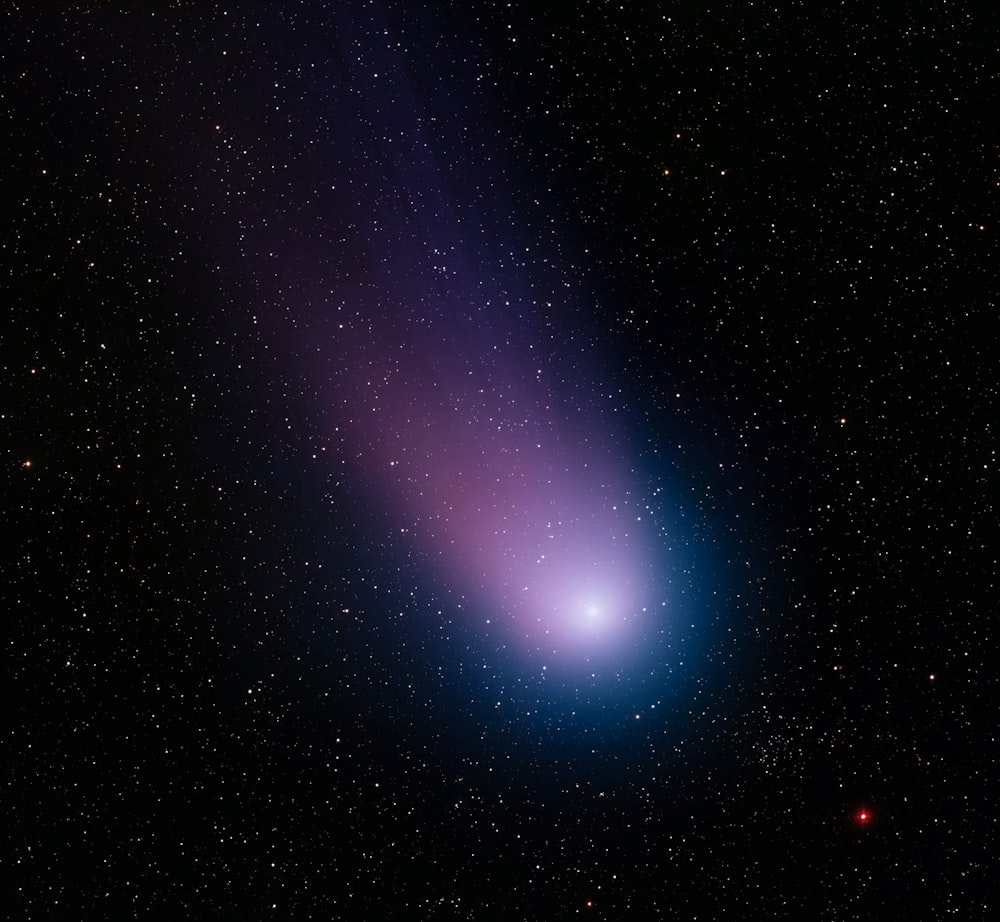 a bright blue object in the middle of the night sky