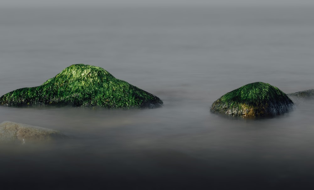 a couple of rocks that are in the water