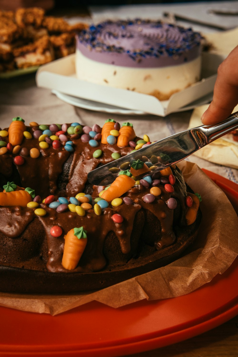 a person cutting a cake with a knife