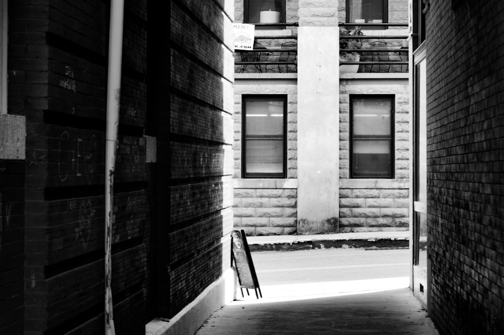 a black and white photo of an alley way