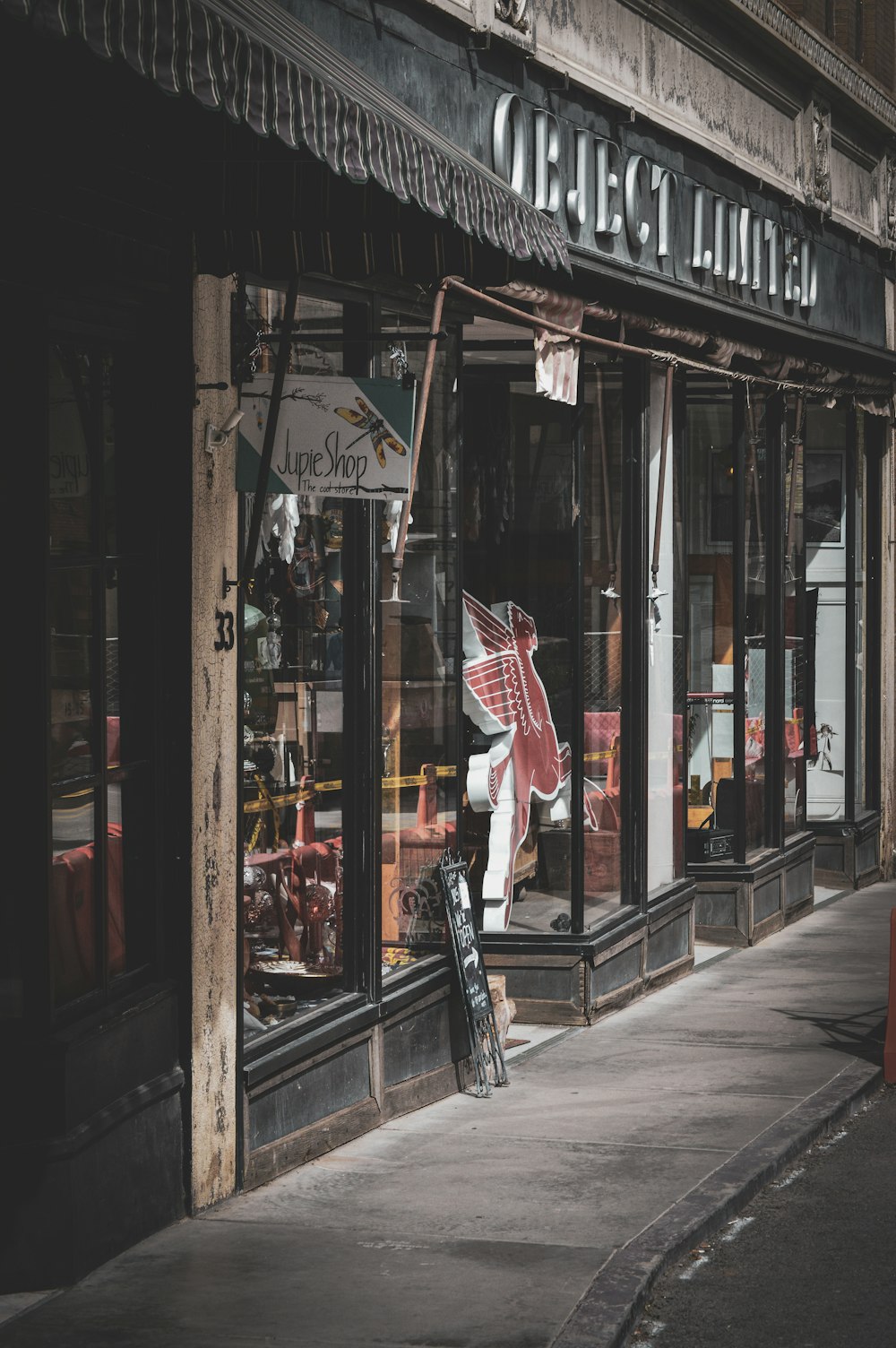 a storefront on a city street with a bicycle leaning against it
