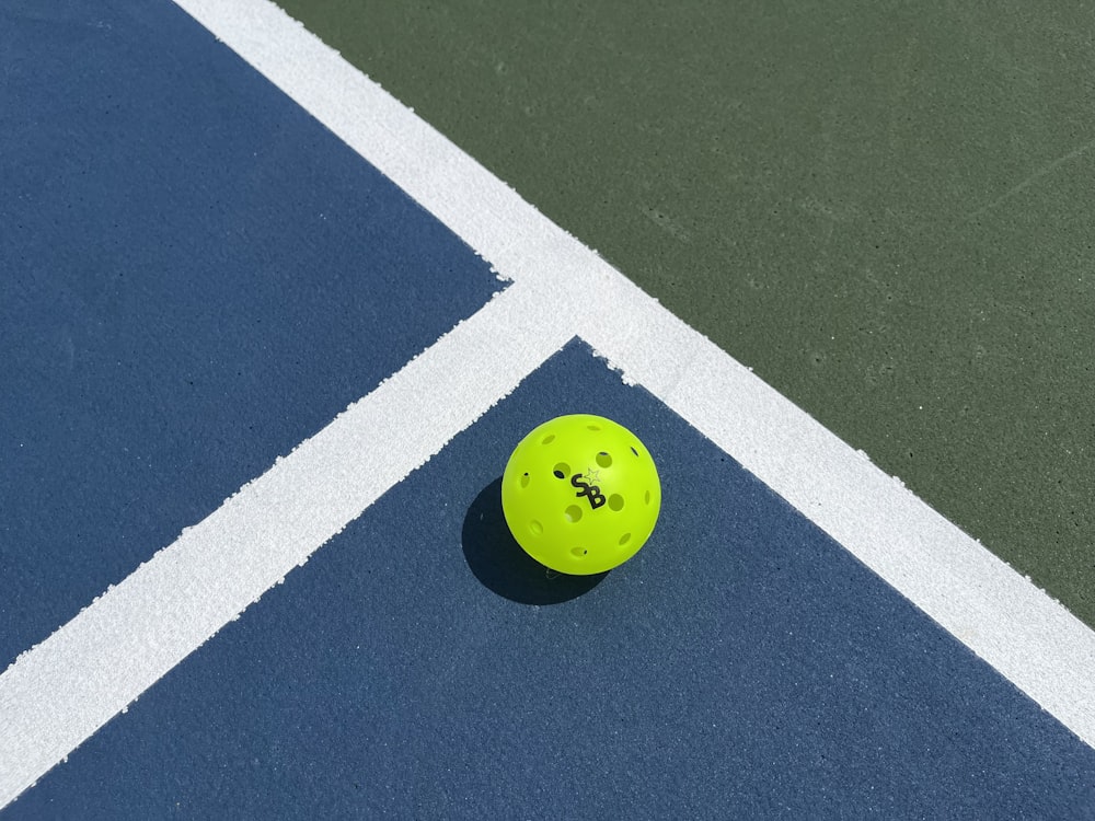 a tennis ball sitting on a tennis court