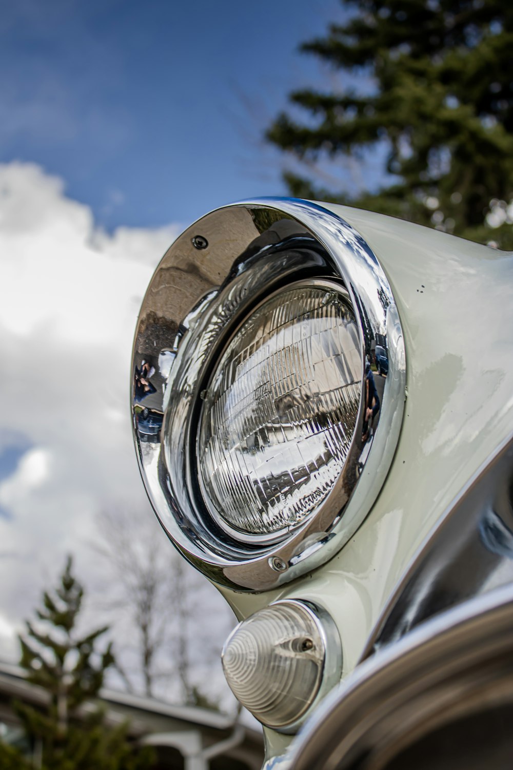 a close up of a headlight on a classic car