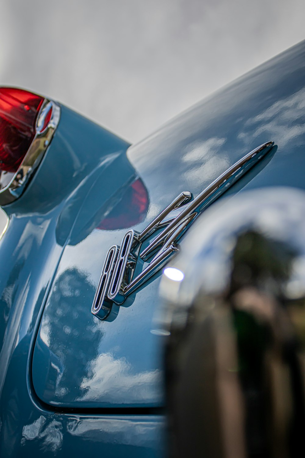 a close up of the tail end of a blue car