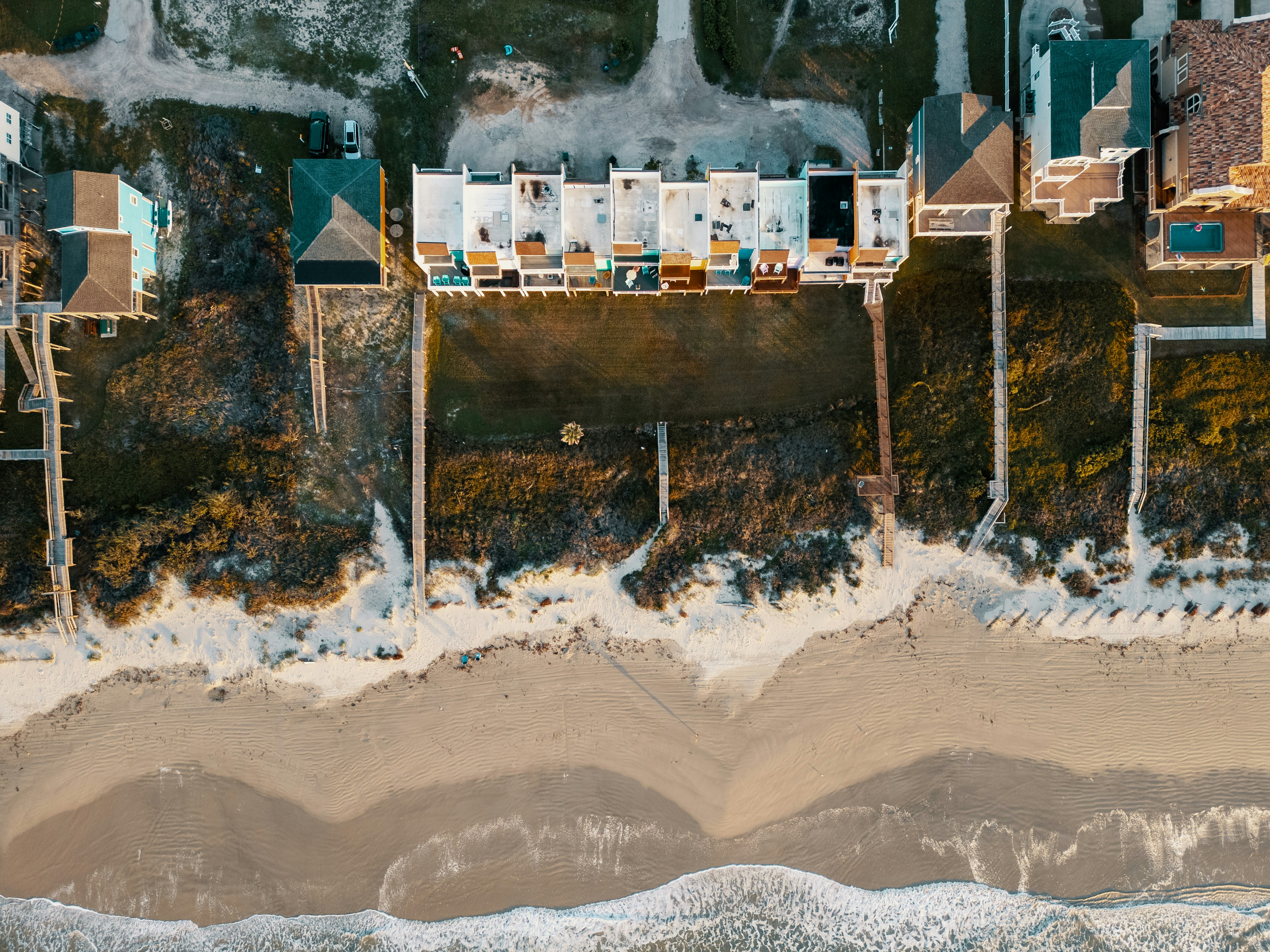 a bird's eye view of a beach and houses