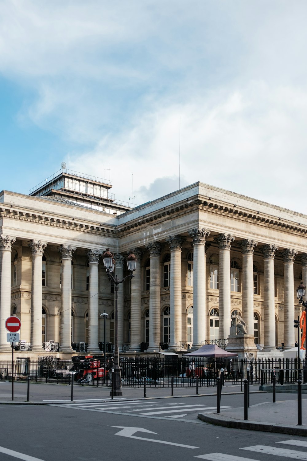 a large building with columns and a clock tower