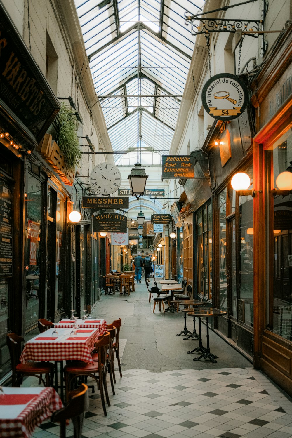 a restaurant with tables and chairs and a skylight