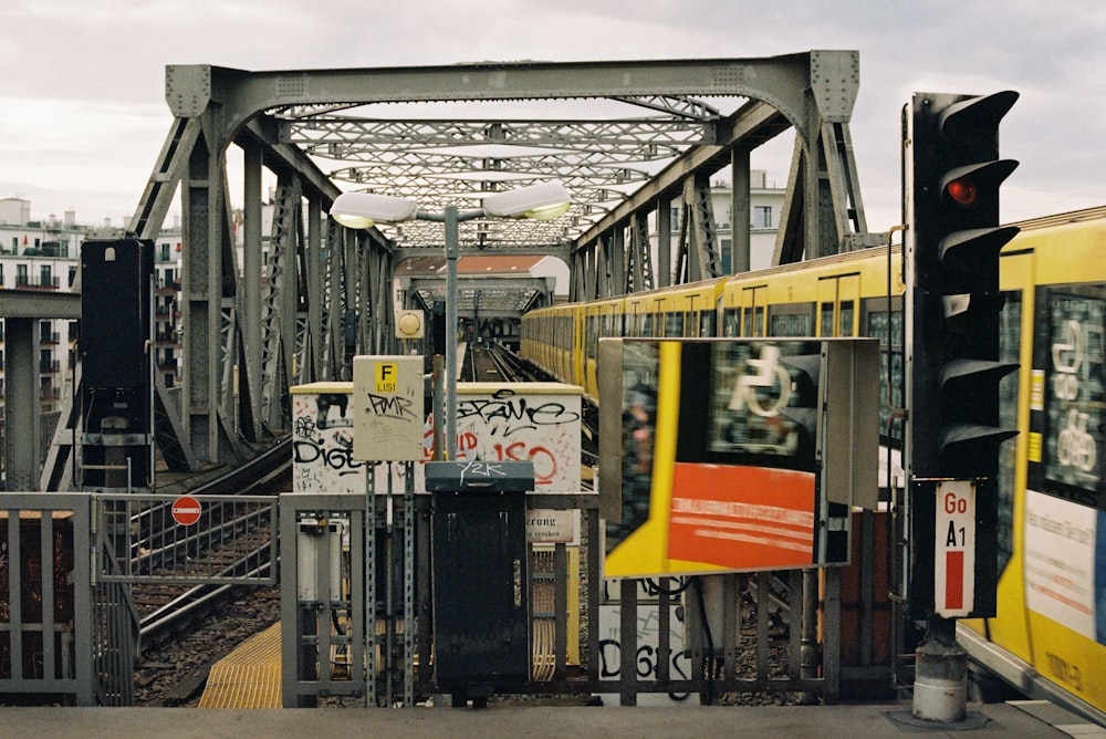 a train traveling over a bridge next to a traffic light