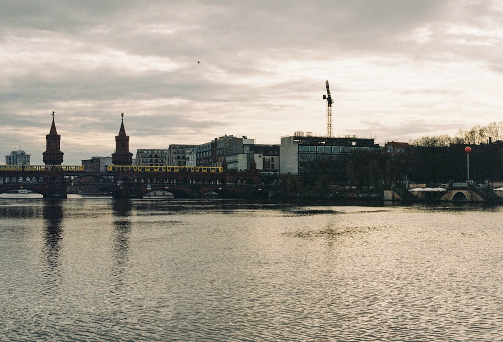 a large body of water with a bridge in the background