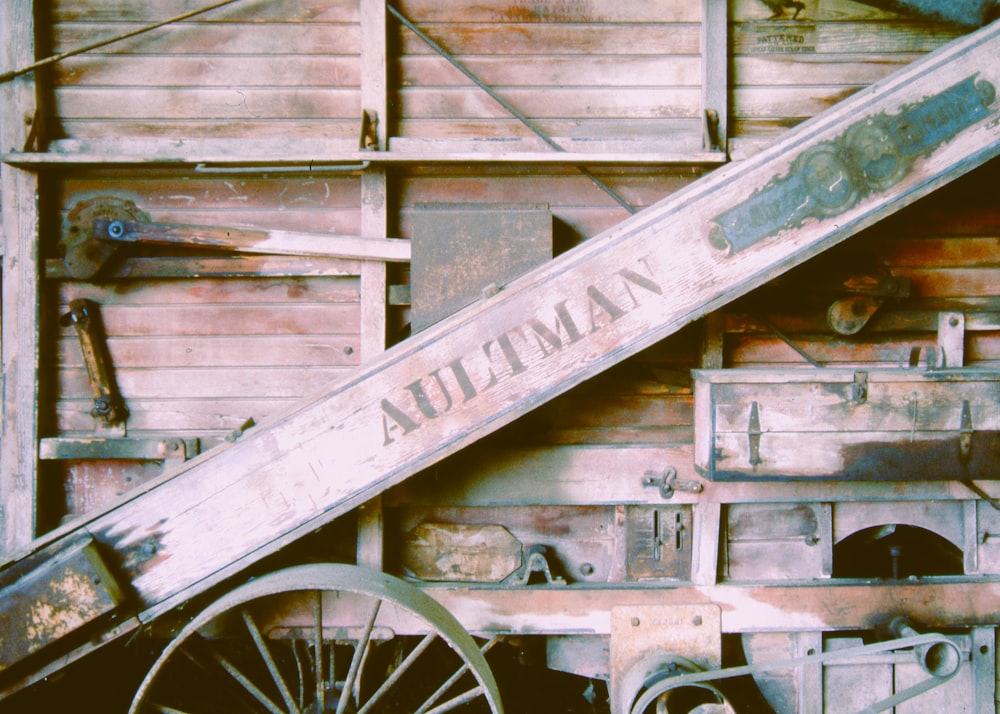 an old wooden wagon with a sign on it