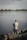 a man standing on a boat holding a fishing rod