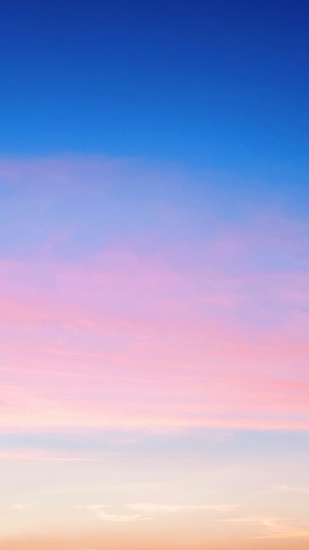 a plane flying in the sky at sunset