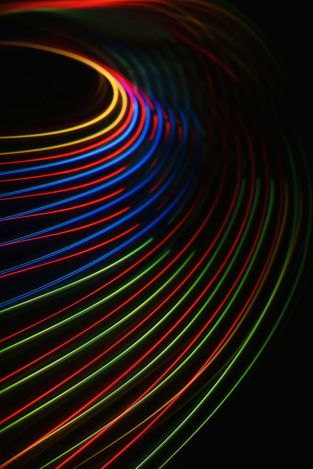 a black background with colorful lights in the dark