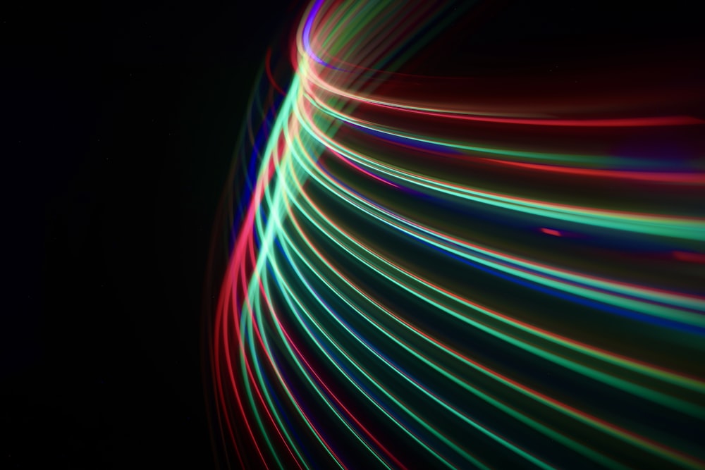 a black background with colorful lines of light