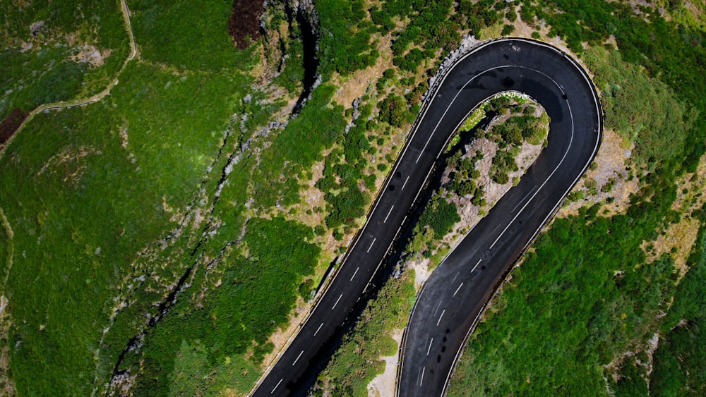 an aerial view of a winding road in the mountains