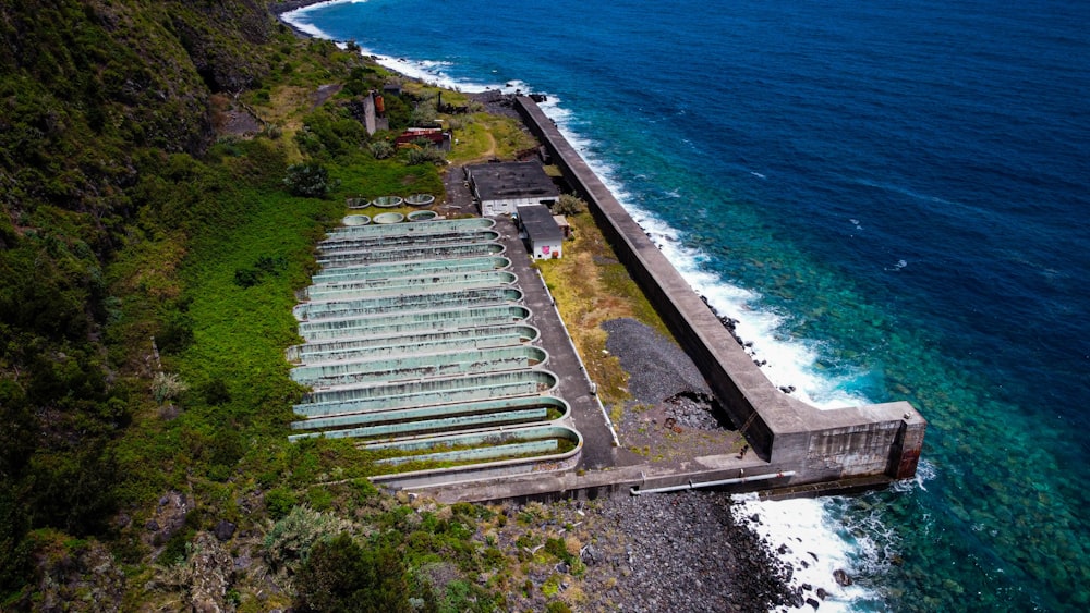 an aerial view of a building next to the ocean